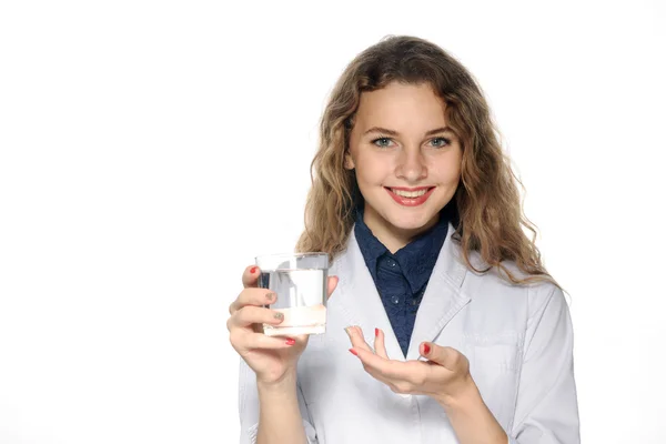 Médico sorrindo e segurando na mão um copo de água — Fotografia de Stock