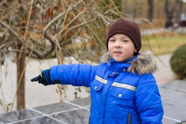 Şehrin arka plan işaret mavi ceketli çocuk
