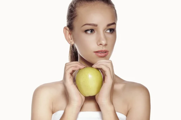 Woman holds big green apple in front of her face. — Stock Photo, Image