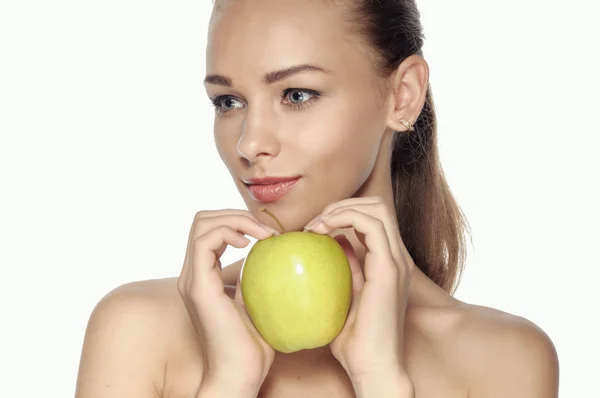 Girl holds a big green apple in front of her face. — Stock Photo, Image