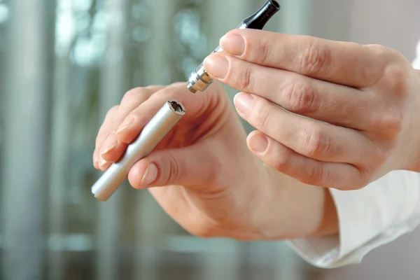 Mão feminina desprende parte do cigarro eletrônico — Fotografia de Stock