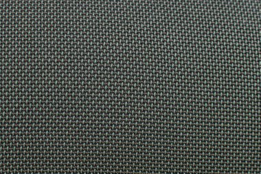 Koyu yeşil hoparlör yüzey dokusuna yakın çekim. Makro. Örgü örülmüş yüzey. Metal ızgara, ağ hoparlörü, koyu renk kumaş yükseltici parçası. Sözcü ızgarası