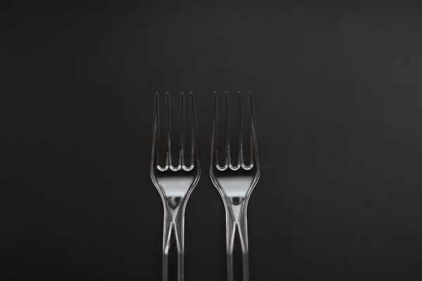 stock image Transparent plastic forks isolated on black background. 