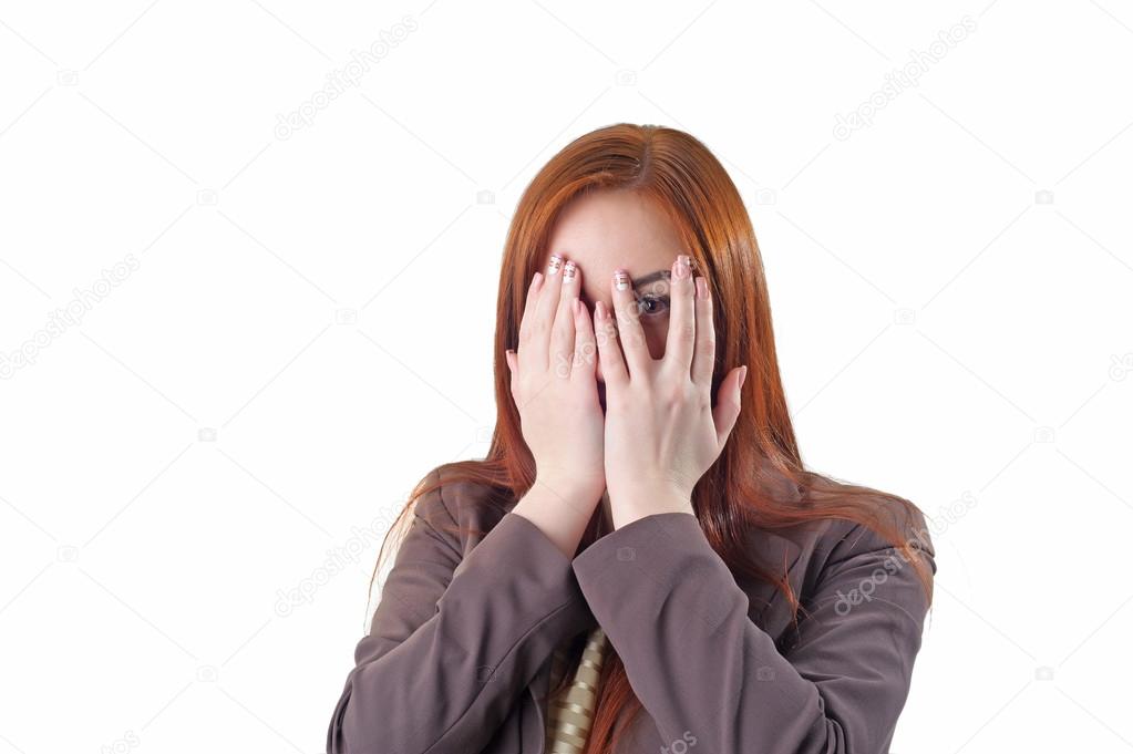 Redhead woman covering her face