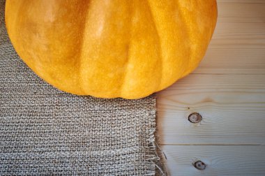 Autumn pumpkin on a wooden background in a rustic style