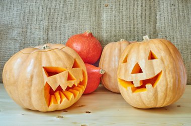 Halloween red and orange pumpkins on a wooden background in a ru