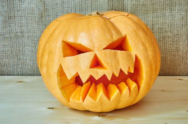 Halloween orange pumpkin on a wooden background in a rustic styl