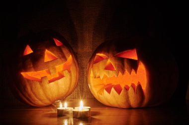 Halloween orange pumpkins jack lantern with candles on a wooden
