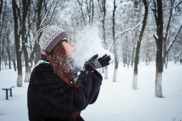 Beauty Winter Girl Blowing Snow in frosty winter Park — Stock Photo, Image