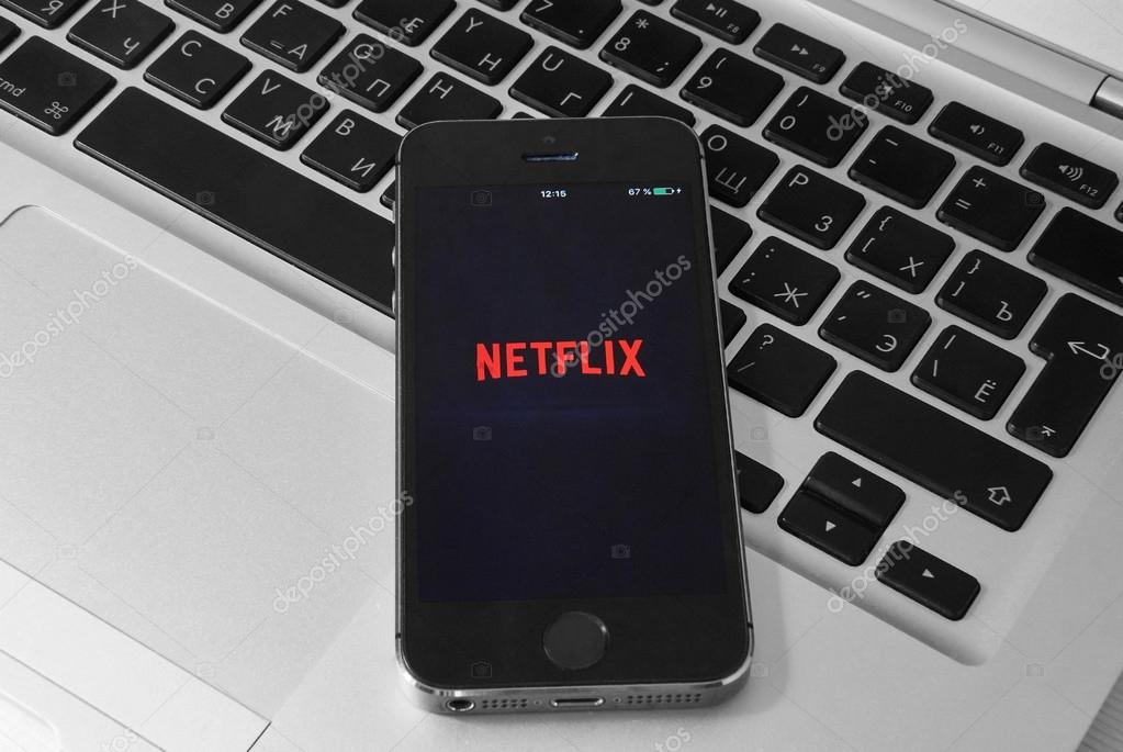 KRIVOY ROG, UKRAINE - NOVEMBER 19, 2015: iPhone 5s on laptop with mobile application for Netflix on the screen.