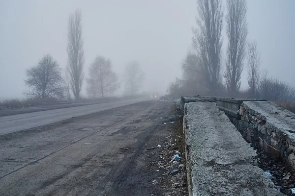 Car in fog with headlights — Stock Photo, Image