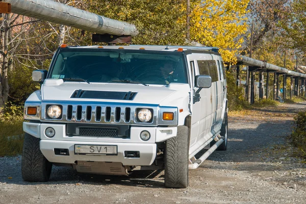 White Hummer H2 limousine at the rural street — Stock Photo, Image
