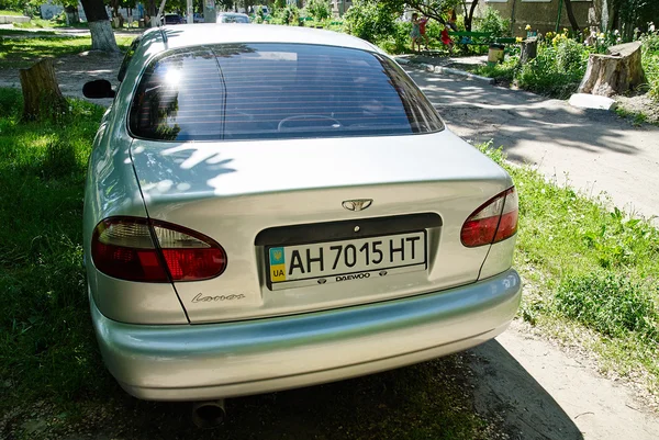 Silver Daewo Lanos on rural road — Stock Photo, Image