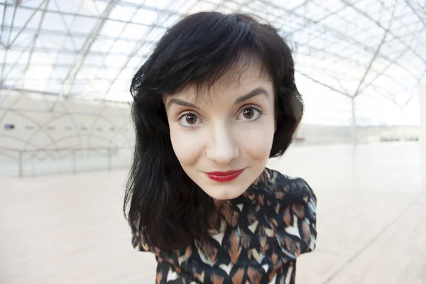 Young woman with red lipstick watching ahead — Stock Photo, Image