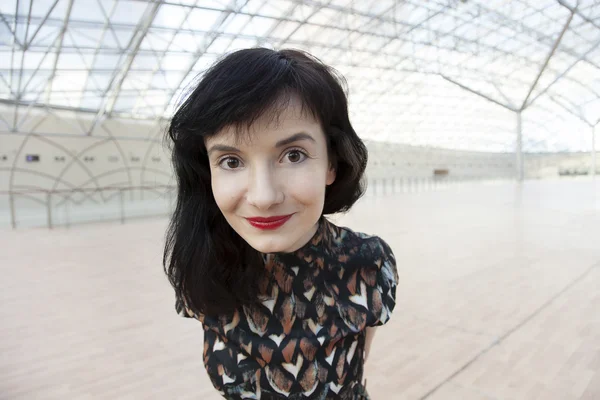 Young woman with red lipstick watching ahead — Stock Photo, Image