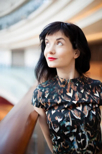 Young woman with red lipstick watching ahead — Stock Photo, Image