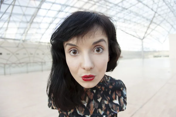 Young woman with red lipstick watching ahead — Stock Photo, Image