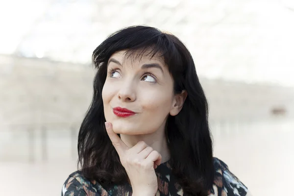 Young woman with red lipstick watching ahead — Stock Photo, Image