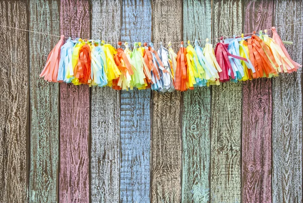 bright colorful paper garland on the fence