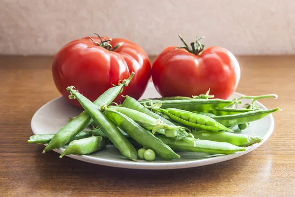 bright red tomatoes and green peas