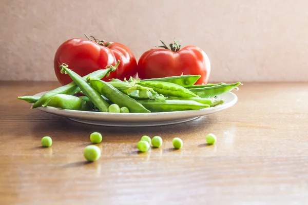 bright red tomatoes and green peas