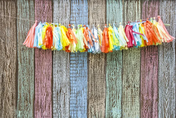 Bright colorful paper garland on the fence Stock Photo