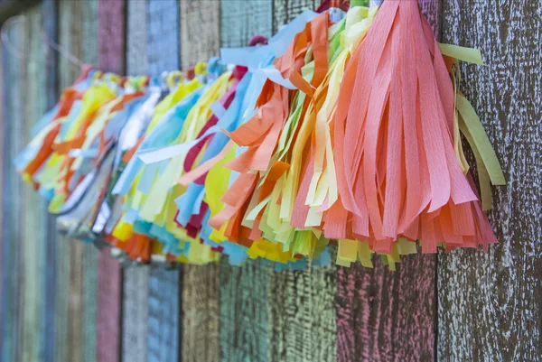 Bright colorful paper garland on the fence Stock Image