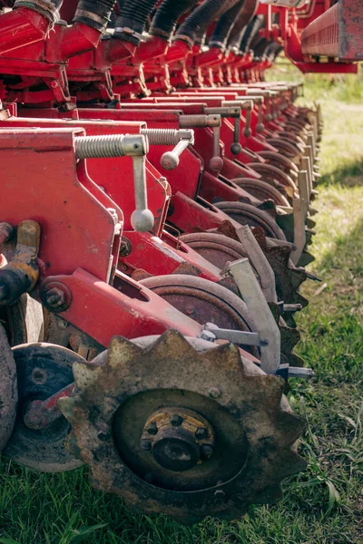 Old farming machinery with vibrant red colors in the field