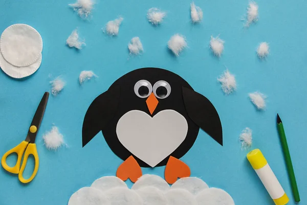 Children\'s winter craft Penguin made of paper and cotton wool. Children\'s art project. DIY concept. Easy craft for kids