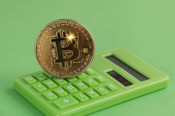 Gold coin Bitcoin, Green Calculator on Green background. Eco Crypto and ICO concept — Stock Photo, Image