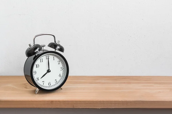 Vintage alarm clock on wood shelf  ( alarm clock show 8 o`clock )