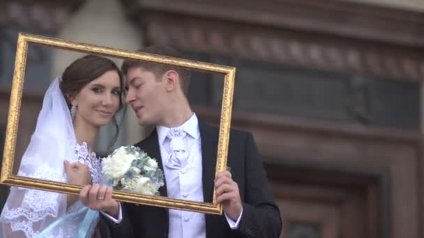 Bride and groom in the picture frame — Stock Video