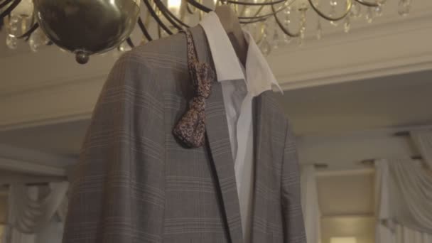 Shirt, a jacket and a butterfly on a hanger — Stock Video