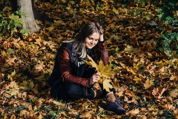 Ung kvinna höst landskap röd gul lönn blad, i en orange stickad varm tröja — Stockfoto