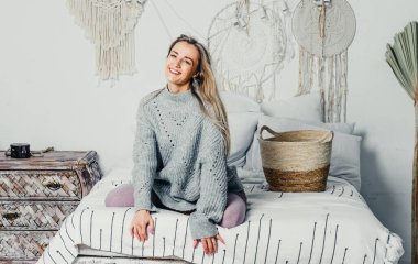 Bej takım elbiseli, uzun saçlı genç ve güzel bir kadın model. Noel ağacı.