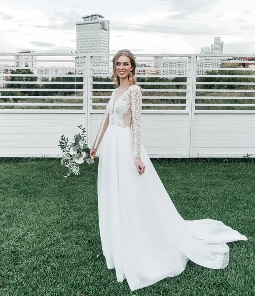 Прекрасная красивая юная стройная невеста в просторном элегантном белом свадебном платье с кружевной улыбкой нежно — стоковое фото