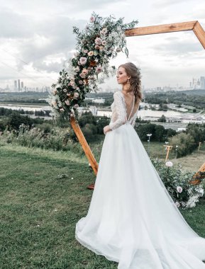 Havadar, beyaz bir gelinlik içinde hoş, genç, narin bir gelin dantelli bir gülücük nazikçe