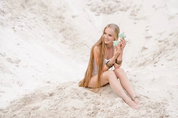 Young slender beautiful slim sexy woman in white swimwear bodysuit on white sand on the beach with — Stock Photo, Image