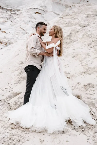 Beautiful wedding couple bride and groom at wedding day outdoors at ocean beach. Happy marriage