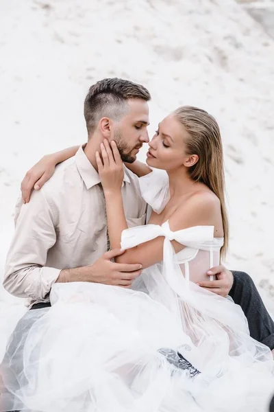 Beautiful wedding couple bride and groom at wedding day outdoors at ocean beach. Happy marriage