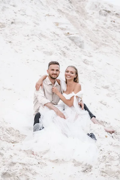 Beautiful wedding couple bride and groom at wedding day outdoors at ocean beach. Happy marriage