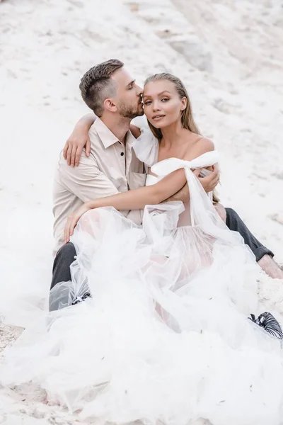 Beautiful wedding couple bride and groom at wedding day outdoors at ocean beach. Happy marriage