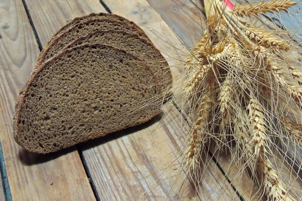 Rye wheat ears slices of fresh-baked bread vintage copper tray food and drink concept.