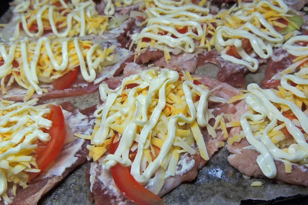 baked pig meat with vegetables and cheese, on a plate, on a white background, isolate