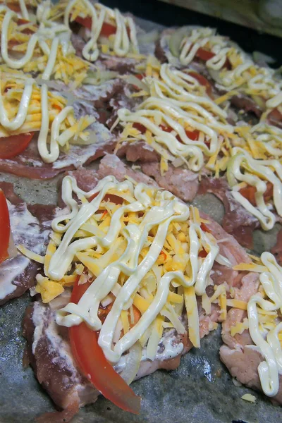 baked pig meat with vegetables and cheese, on a plate, on a white background, isolate