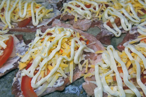 baked pig meat with vegetables and cheese, on a plate, on a white background, isolate