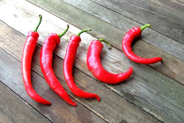 Chili pepper on wooden background — Stock Photo, Image