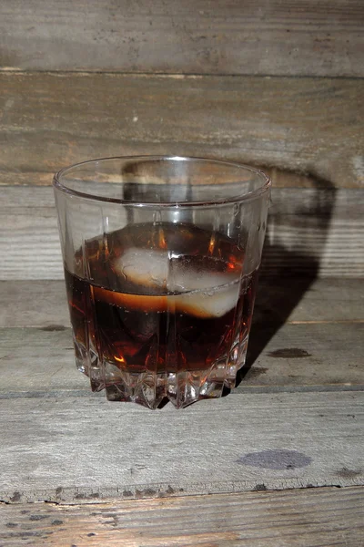 Whiskey with ice in glass — Stock Photo, Image