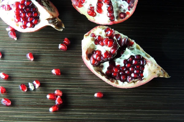 Pomegranate on wooden background — Stock Photo, Image