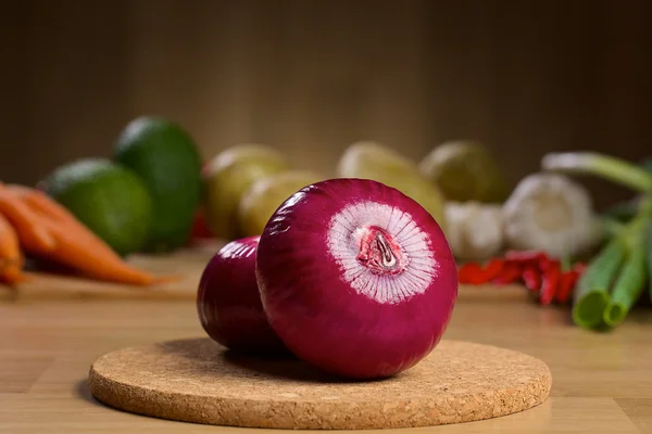 Red onion bulb on the wooden background — Stock Photo, Image